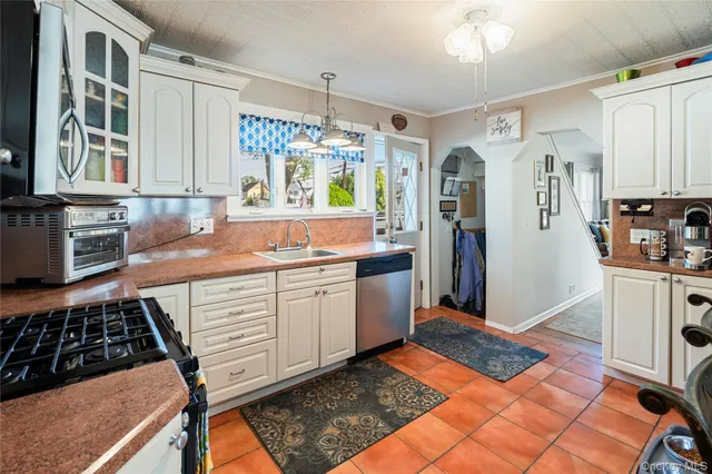 a kitchen with stainless steel appliances granite countertop a refrigerator and a stove