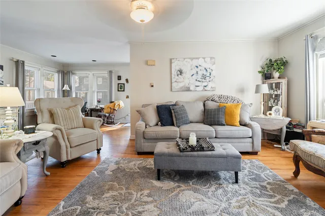 a living room with furniture or couch and a wooden floor