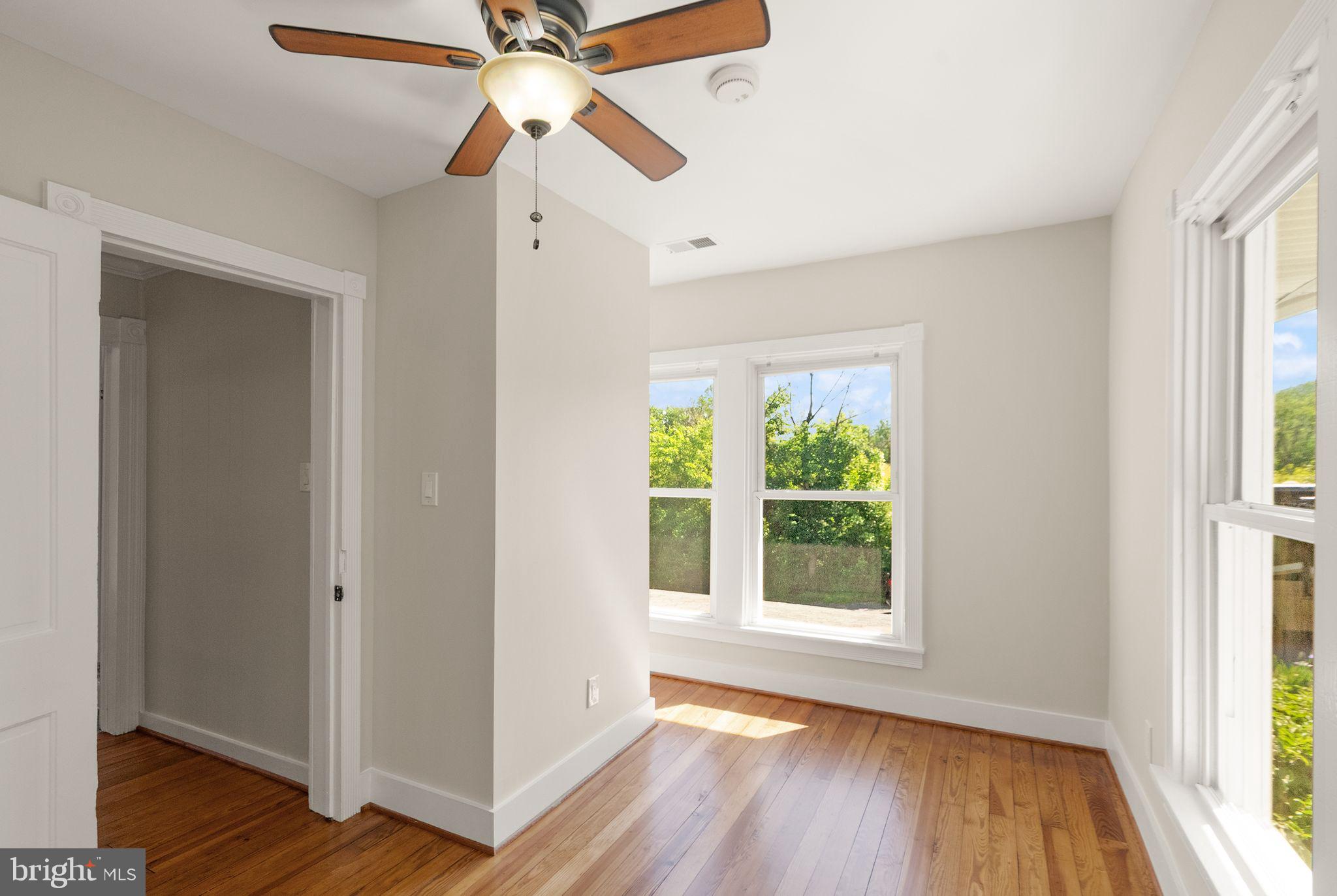 37151 Branchriver Road Purcellville, VA 20132 - Photo 40 of 63 a view of an empty room with wooden floor and a window