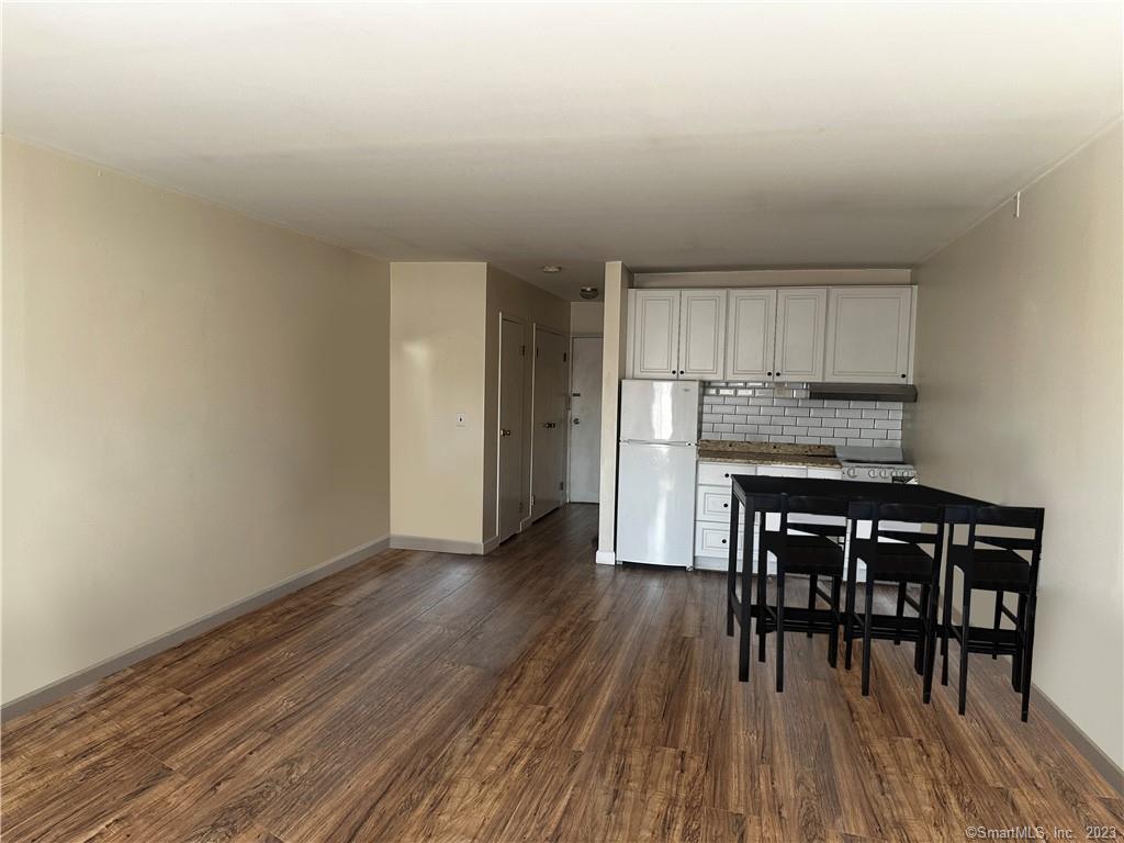 a kitchen with wooden floors and wooden cabinets