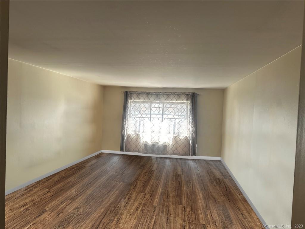 7 Winfield Street, Unit 2 Norwalk, CT 06855 - Photo 2 of 10 wooden floor in an empty room with a window