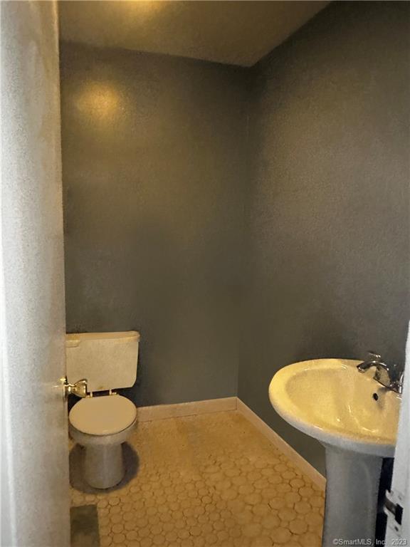 7 Winfield Street, Unit 2 Norwalk, CT 06855 - Photo 4 of 10 a bathroom with a toilet a sink and a mirror