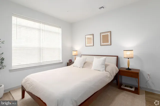 a view of a room with wooden floor and a bathroom
