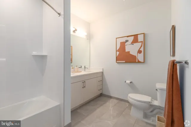 a kitchen with stainless steel appliances granite countertop a refrigerator a sink dishwasher a stove and a refrigerator with wooden floor