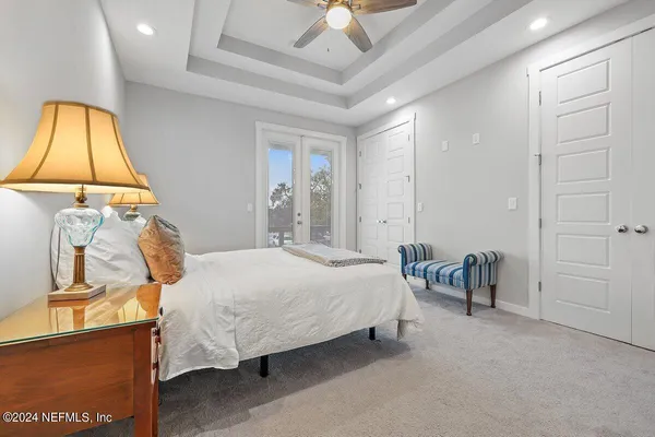 a bedroom with a bed and lamp
