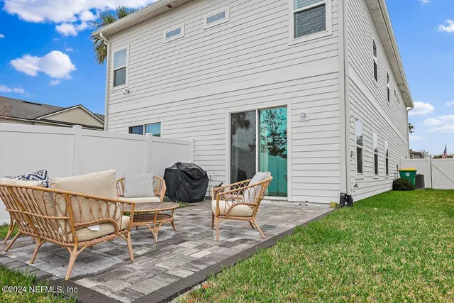 a view of a chairs and table in backyard of the house