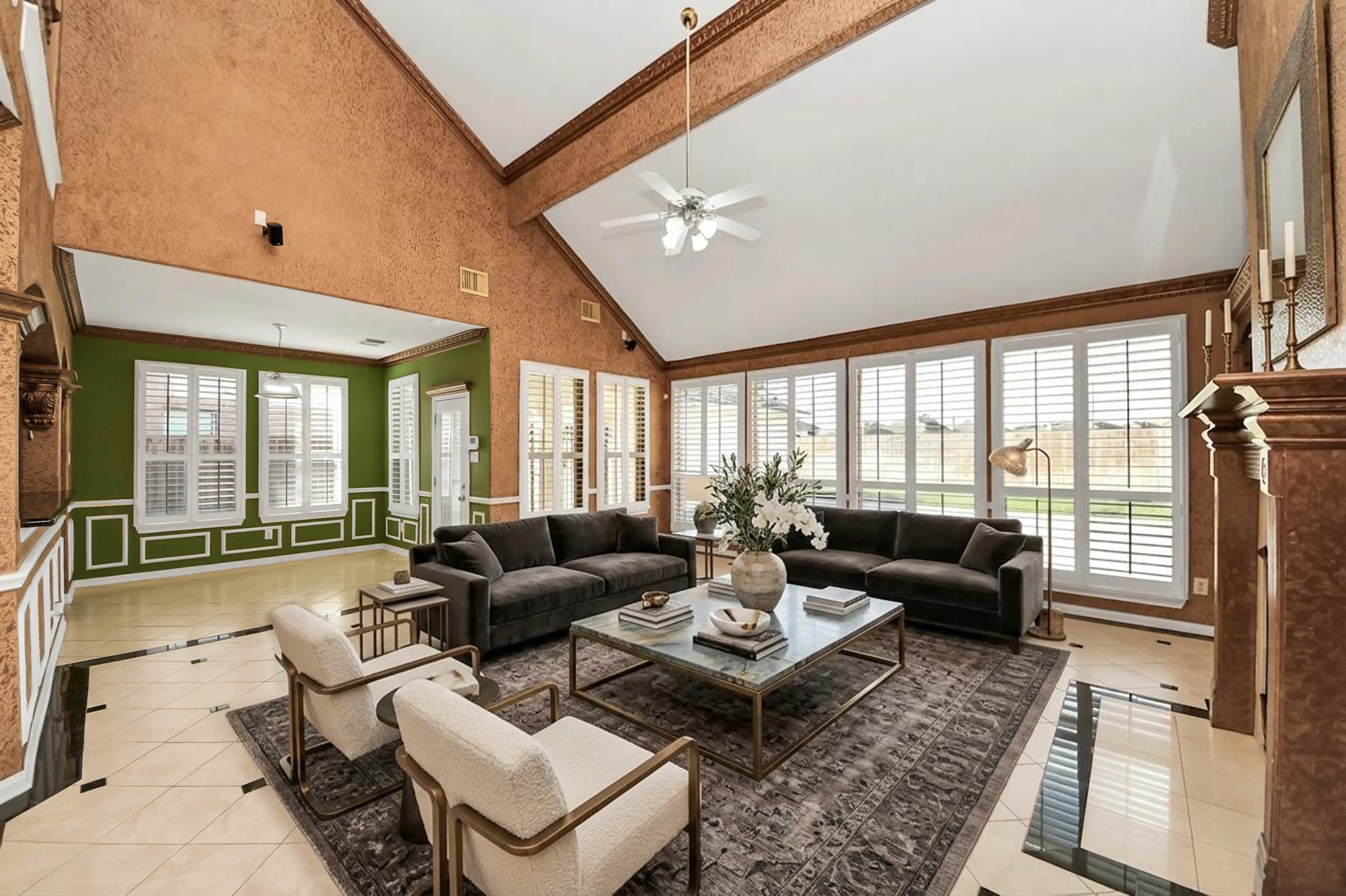 20111 Biscayne Hill Court Spring, TX 77379 - Photo 17 of 44 This spacious living room features a high vaulted ceiling, large windows with plantation shutters, and a mix of elegant textures. The marble tile flooring complements the cozy seating area centered around a modern coffee table. Ideal for entertaining, it offers plenty of natural light and a warm, inviting atmosphere.