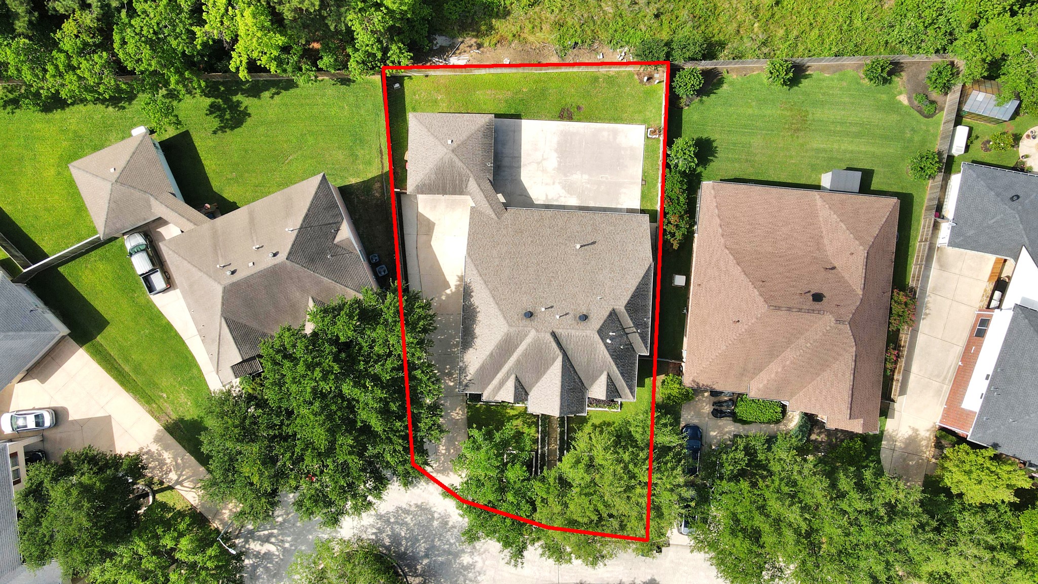 20111 Biscayne Hill Court Spring, TX 77379 - Photo 40 of 44 This aerial photo shows a single-story home with a spacious driveway and a well-defined property line. The house is surrounded by green lawns and adjacent to similar homes, providing a cozy neighborhood feel. The backyard offers ample space for outdoor activities.