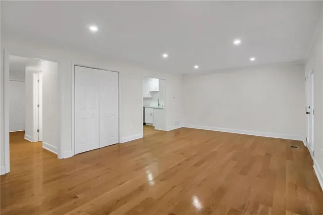 a view of empty room with wooden floor
