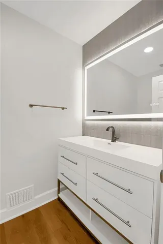 a bathroom with a sink and a mirror