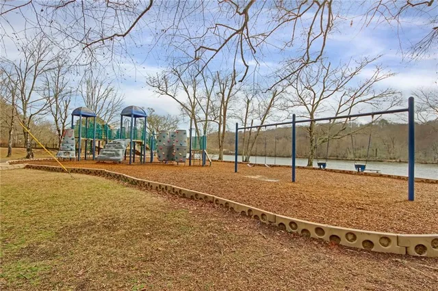 a view of swimming pool with table and chairs
