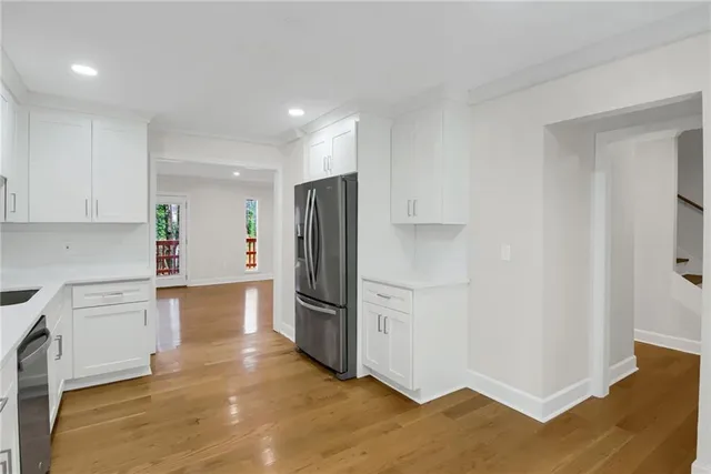 a kitchen with stainless steel appliances a refrigerator and a stove top oven