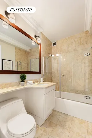 a spacious bedroom with a bed and glass window