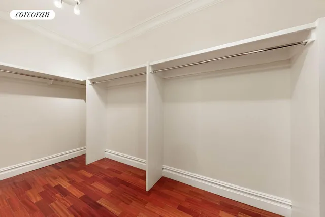 a hallway with furniture and a potted plant