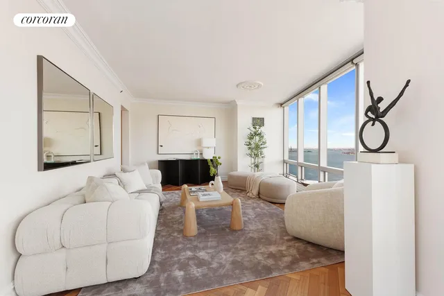a living room with furniture large windows and wooden floor