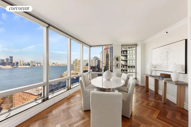 a living room with furniture a flat screen tv and a window