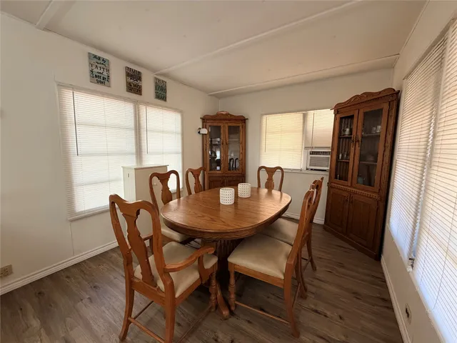 a view of a dining room with furniture and window