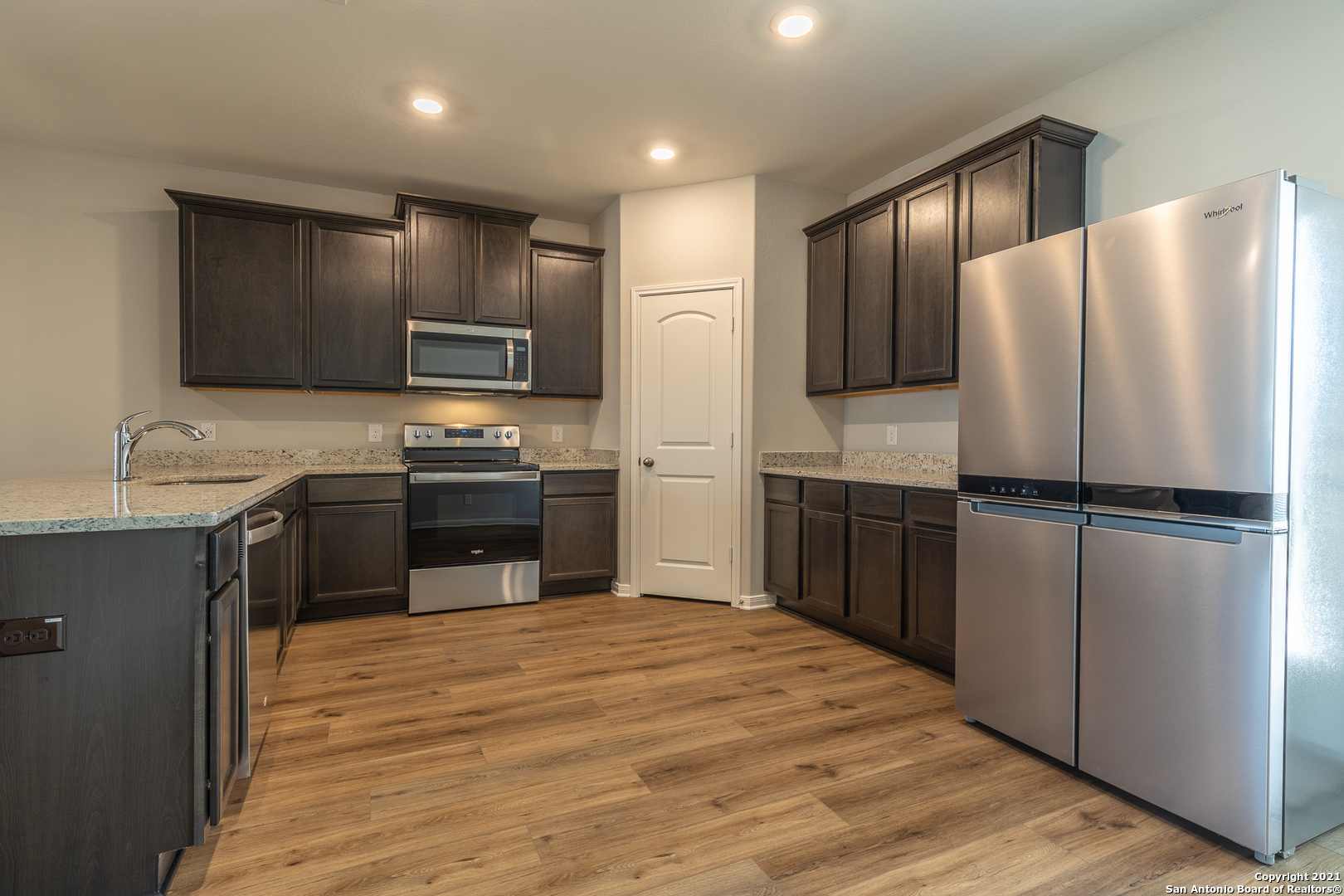 9338 Espadrille Run Converse, TX 78109 - Photo 13 of 46 a kitchen with kitchen island a counter top space stainless steel appliances and cabinets