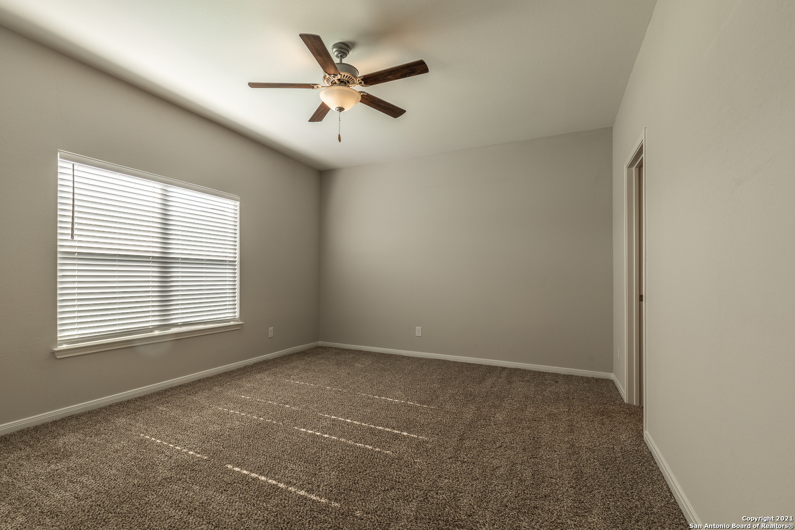 9338 Espadrille Run Converse, TX 78109 - Photo 18 of 46 an empty room with a window and a fan