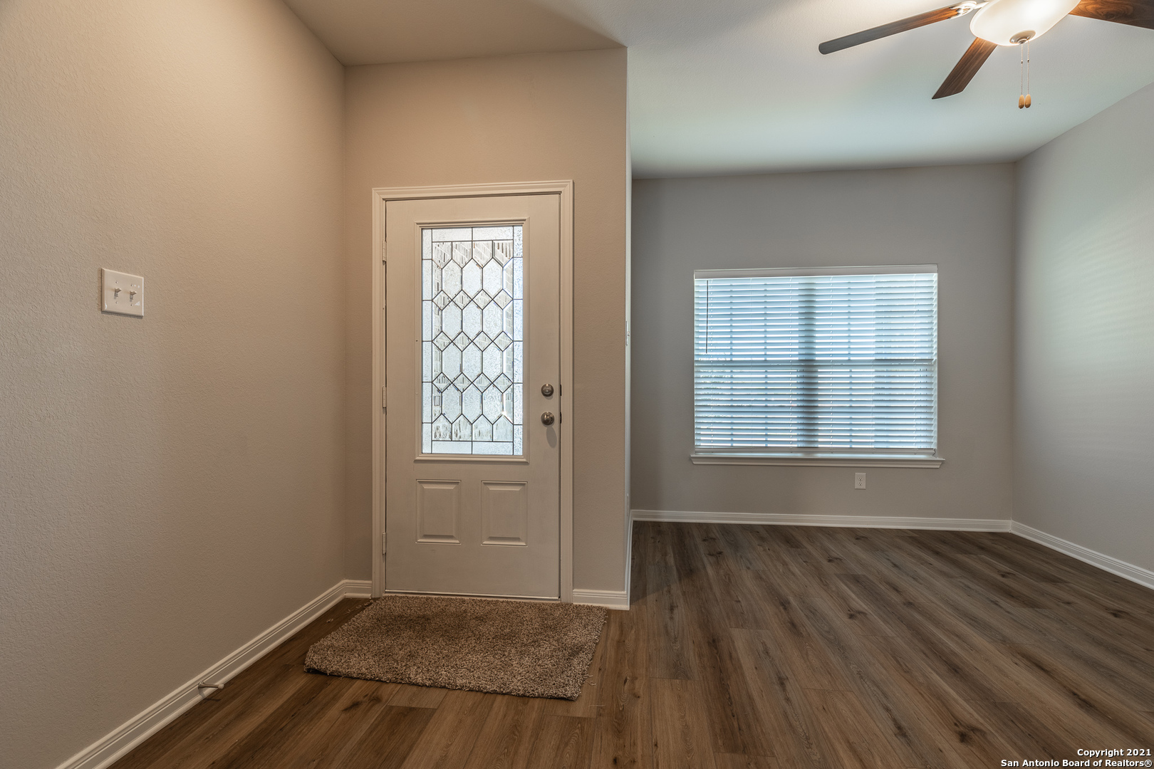 9338 Espadrille Run Converse, TX 78109 - Photo 6 of 46 an empty room with wooden floor and windows