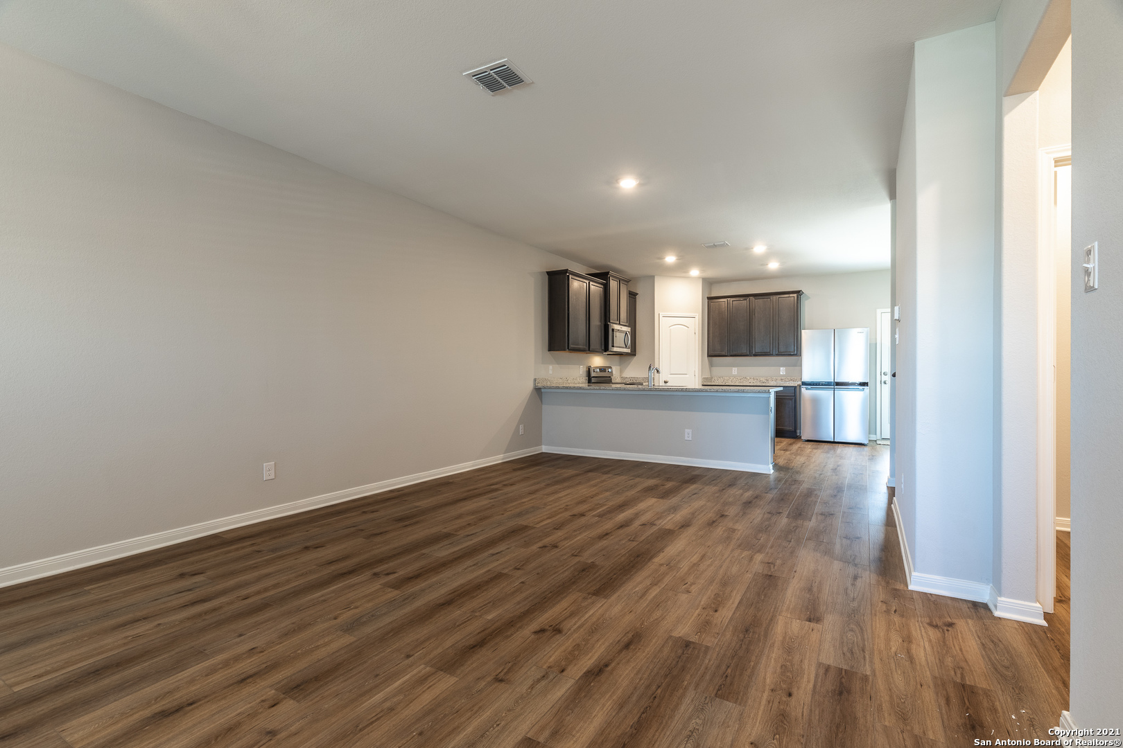 9338 Espadrille Run Converse, TX 78109 - Photo 7 of 46 a view of kitchen with wooden floor and electronic appliances