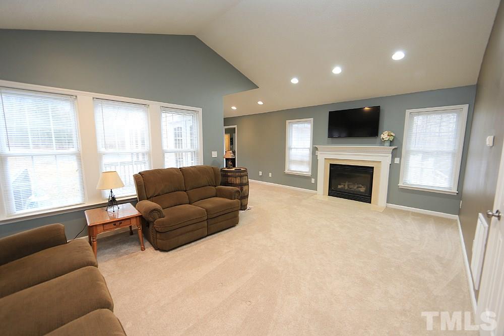 657 Thunder Road Rougemont, NC 27572 - Photo 13 of 29 a living room with furniture a flat screen tv and a fireplace