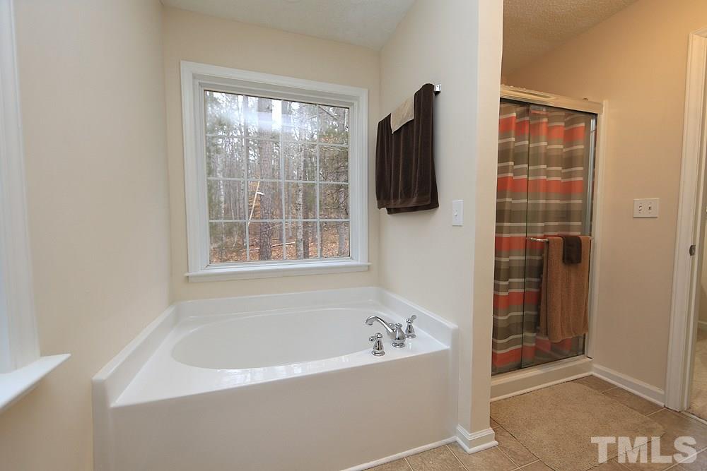 657 Thunder Road Rougemont, NC 27572 - Photo 19 of 29 a bathroom with a bathtub and a shower