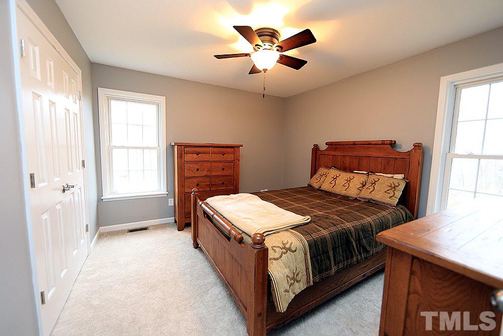 657 Thunder Road Rougemont, NC 27572 - Photo 25 of 29 a bedroom with a bed next to a window