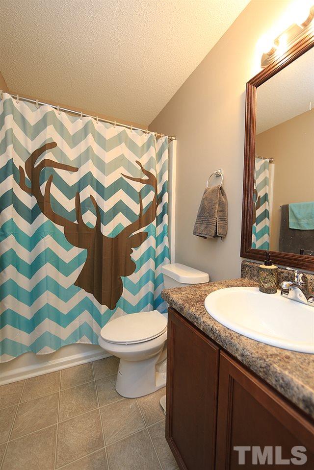 657 Thunder Road Rougemont, NC 27572 - Photo 26 of 29 a bathroom with a granite countertop sink and a mirror
