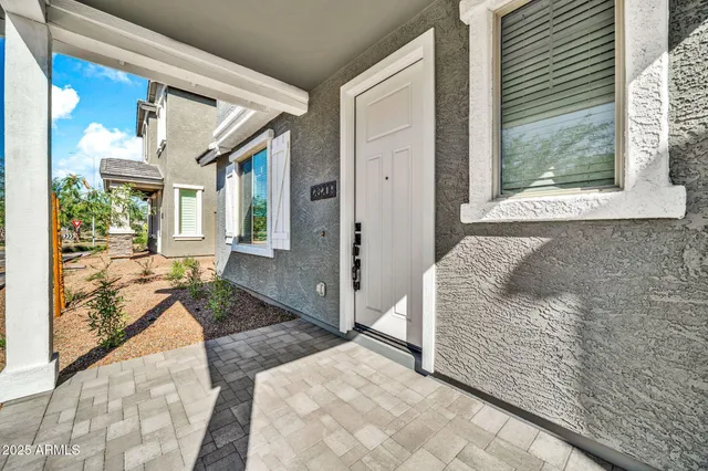 a living room with a bed furniture and next to a window