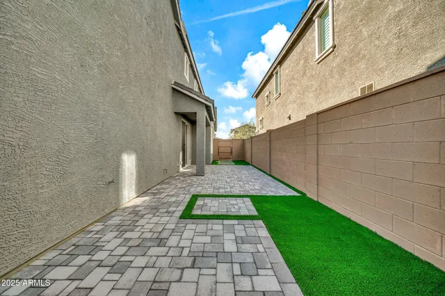 a view of a palm trees front of the house