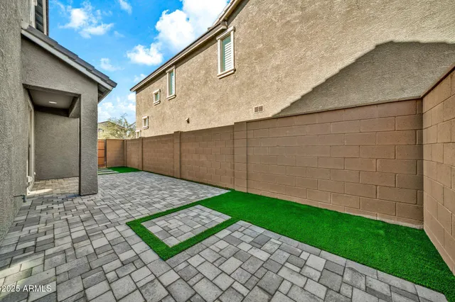 a view of a patio with table and chairs and potted plants