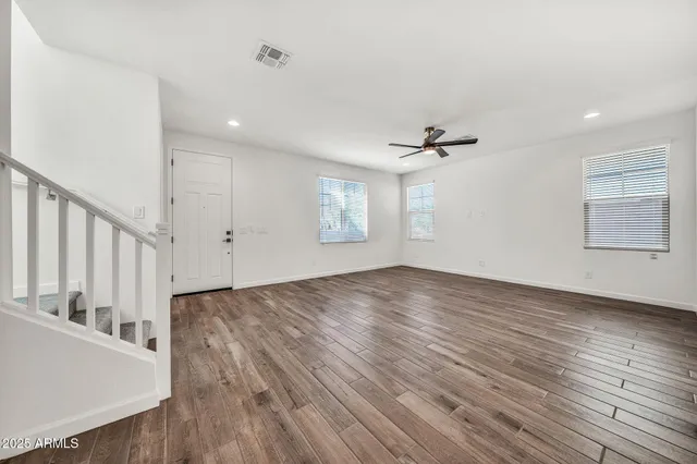 a view of an empty room with wooden floor