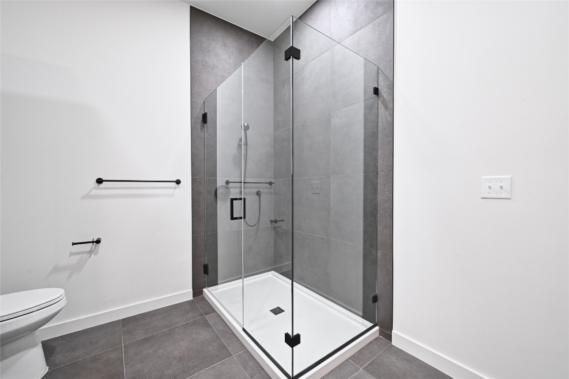 2209 South 1st Street, Unit 118 Austin, TX 78704 - Photo 14 of 36 a bathroom with a shower and toilet