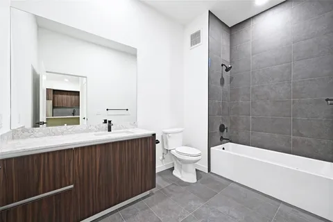 a bathroom with a toilet a sink and bathtub
