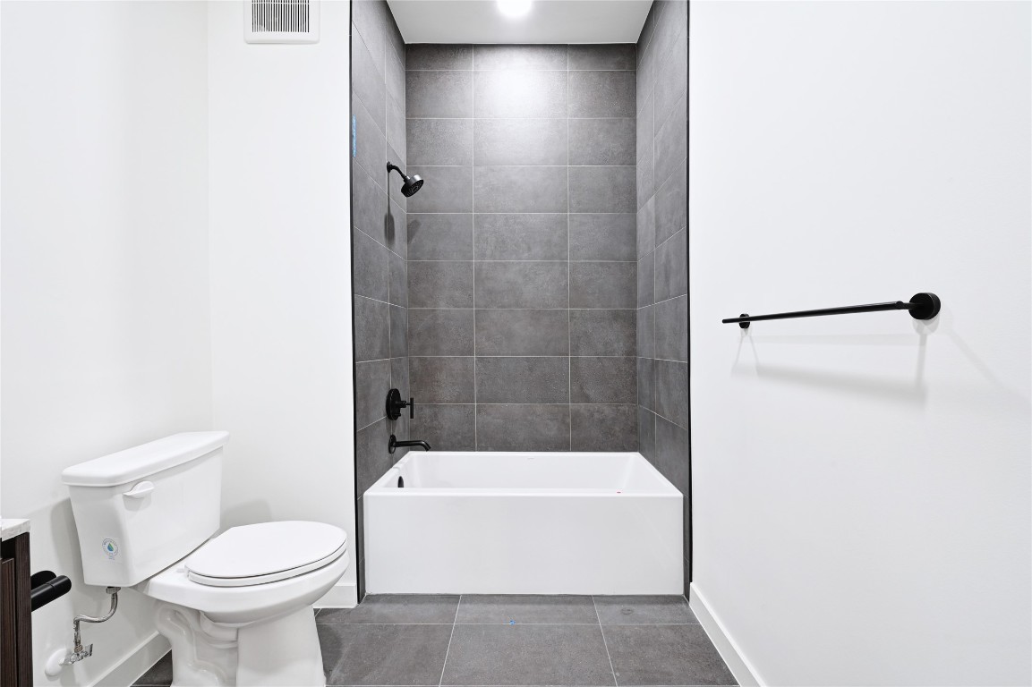 2209 South 1st Street, Unit 118 Austin, TX 78704 - Photo 16 of 36 a white toilet sitting next to a white tub