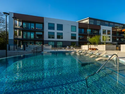 a swimming pool view with a outdoor seating