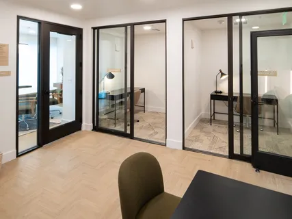 a living room with furniture and a glass door shower