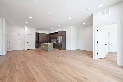a view of a kitchen with a refrigerator and a microwave