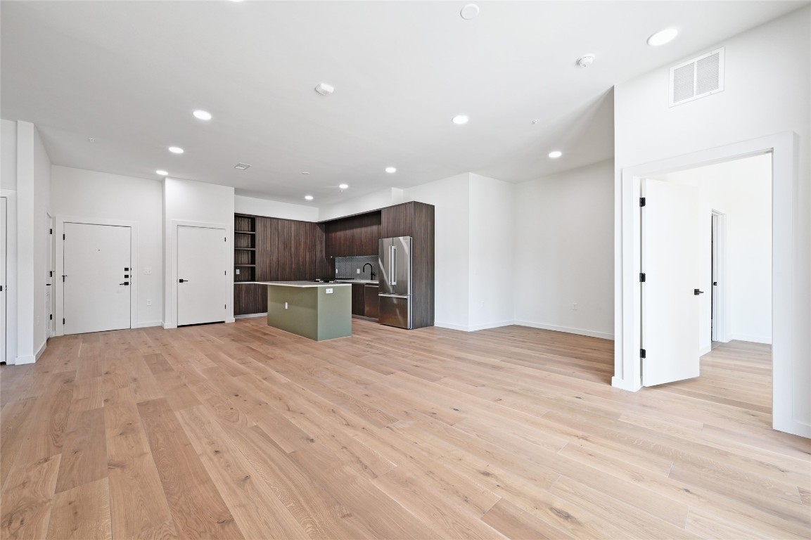 2209 South 1st Street, Unit 118 Austin, TX 78704 - Photo 9 of 36 a view of a kitchen with a refrigerator and a microwave