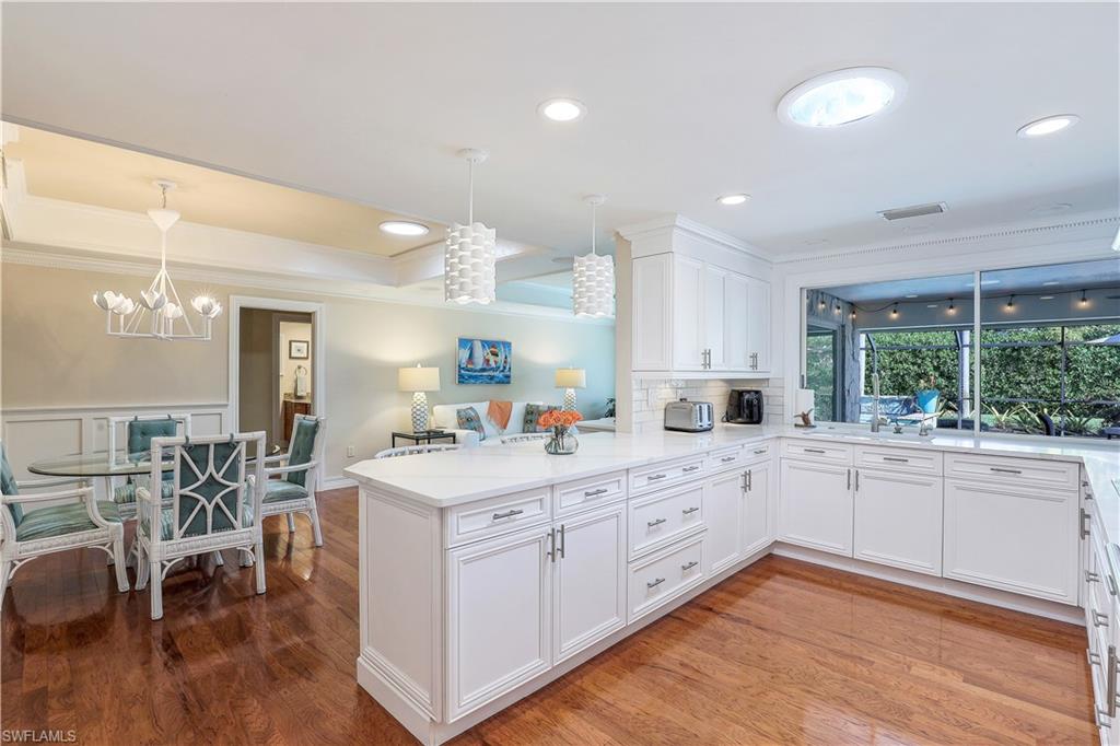 635 Anchor Rode Drive Naples, FL 34103 - Photo 14 of 50 a kitchen with white cabinets and sink