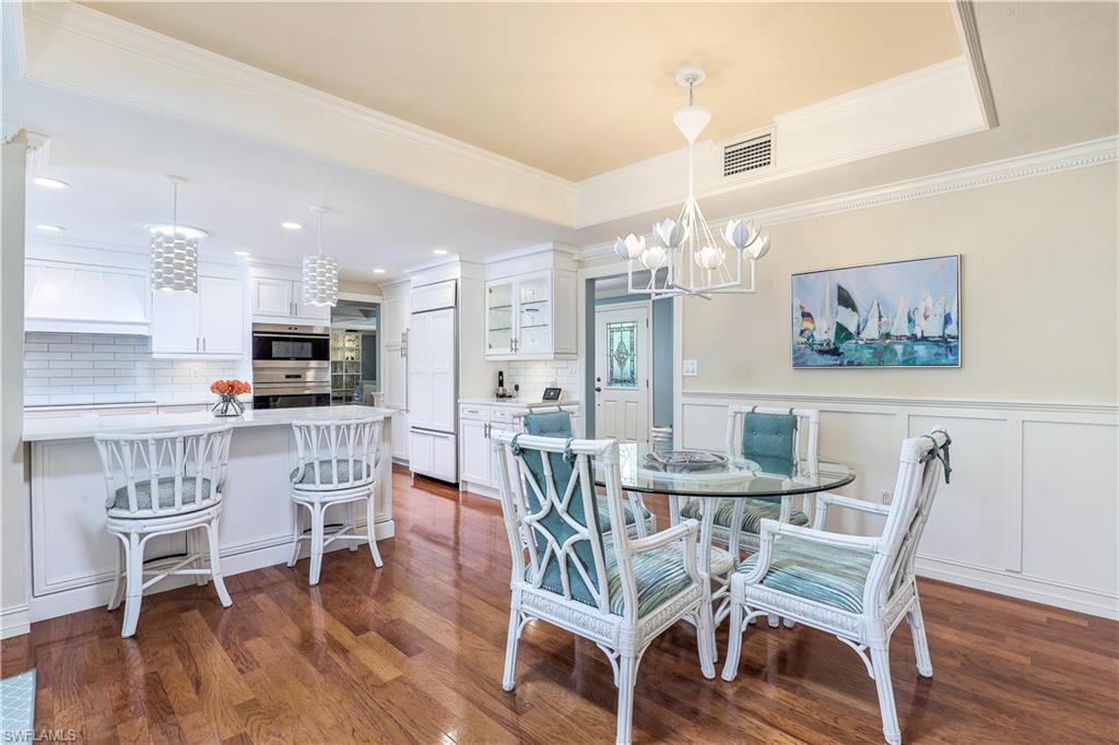 635 Anchor Rode Drive Naples, FL 34103 - Photo 17 of 50 a view of a dining room with furniture and wooden floor