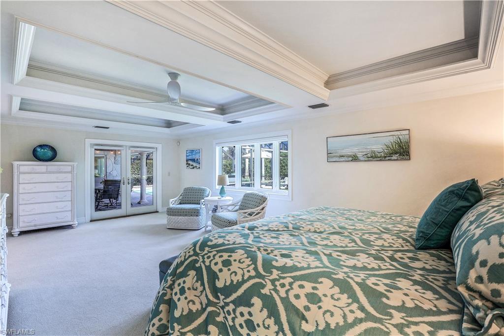 635 Anchor Rode Drive Naples, FL 34103 - Photo 22 of 50 a bedroom with a large bed couch and two large window