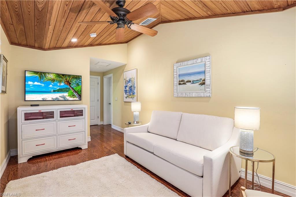 635 Anchor Rode Drive Naples, FL 34103 - Photo 28 of 50 a living room with furniture and a flat screen tv