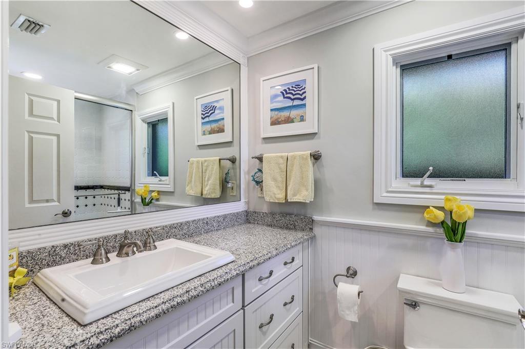 635 Anchor Rode Drive Naples, FL 34103 - Photo 29 of 50 a bathroom with a granite countertop sink and a mirror