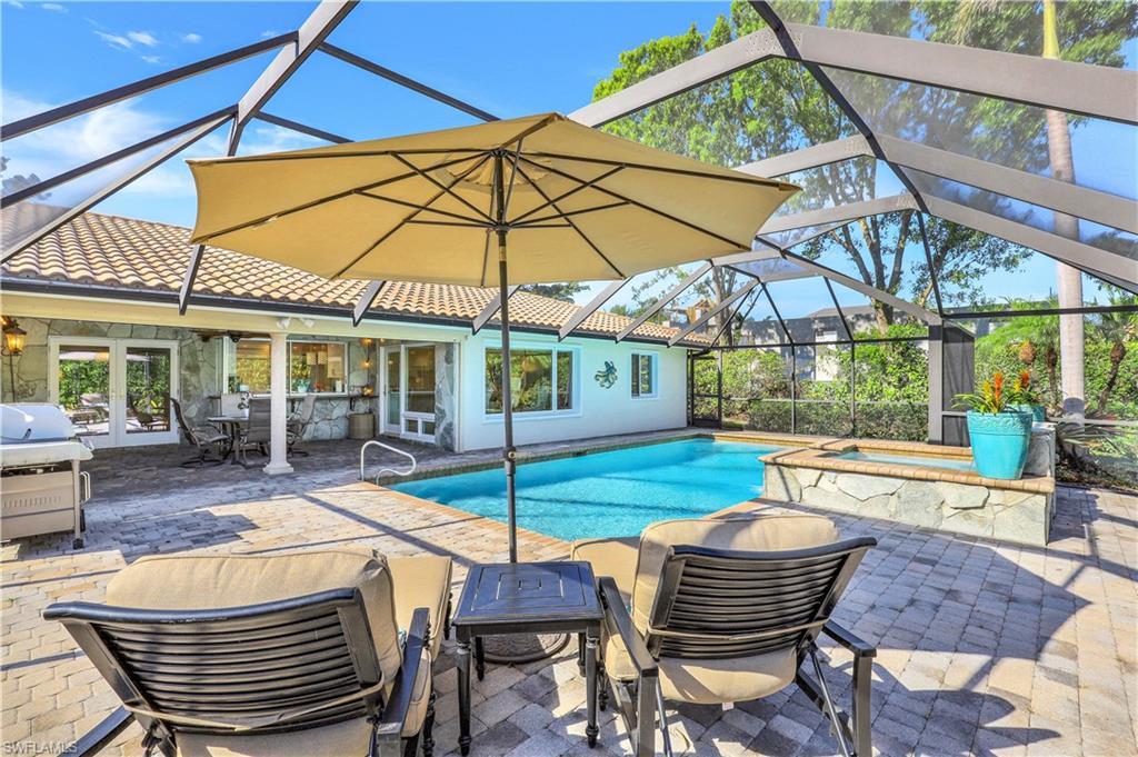 635 Anchor Rode Drive Naples, FL 34103 - Photo 36 of 50 a patio with a table and chairs