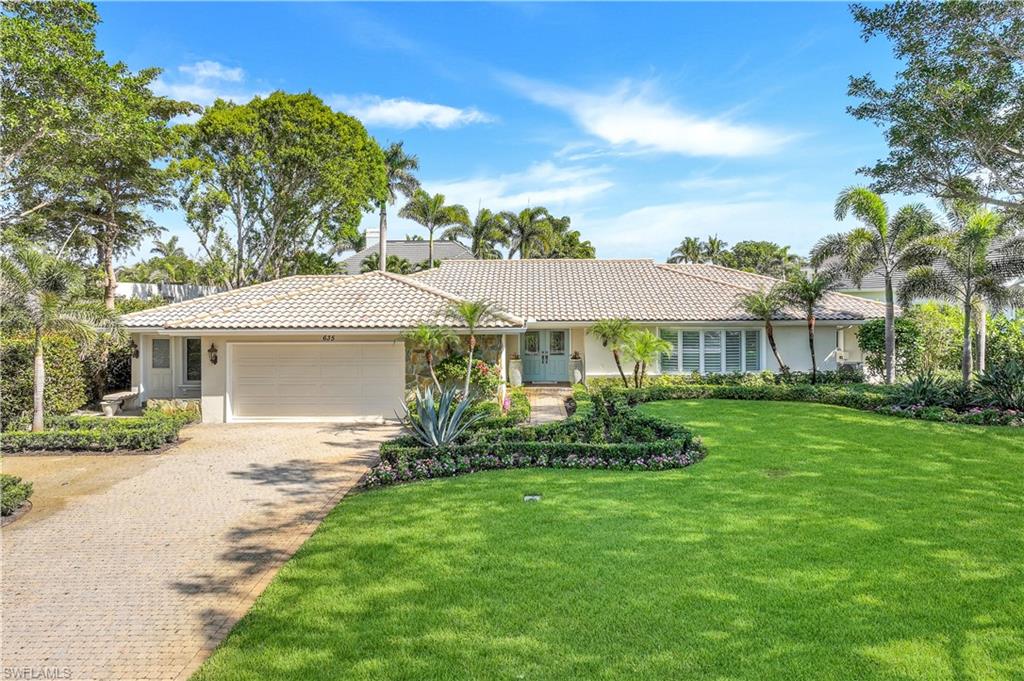 635 Anchor Rode Drive Naples, FL 34103 - Photo 40 of 50 a front view of a house with a garden
