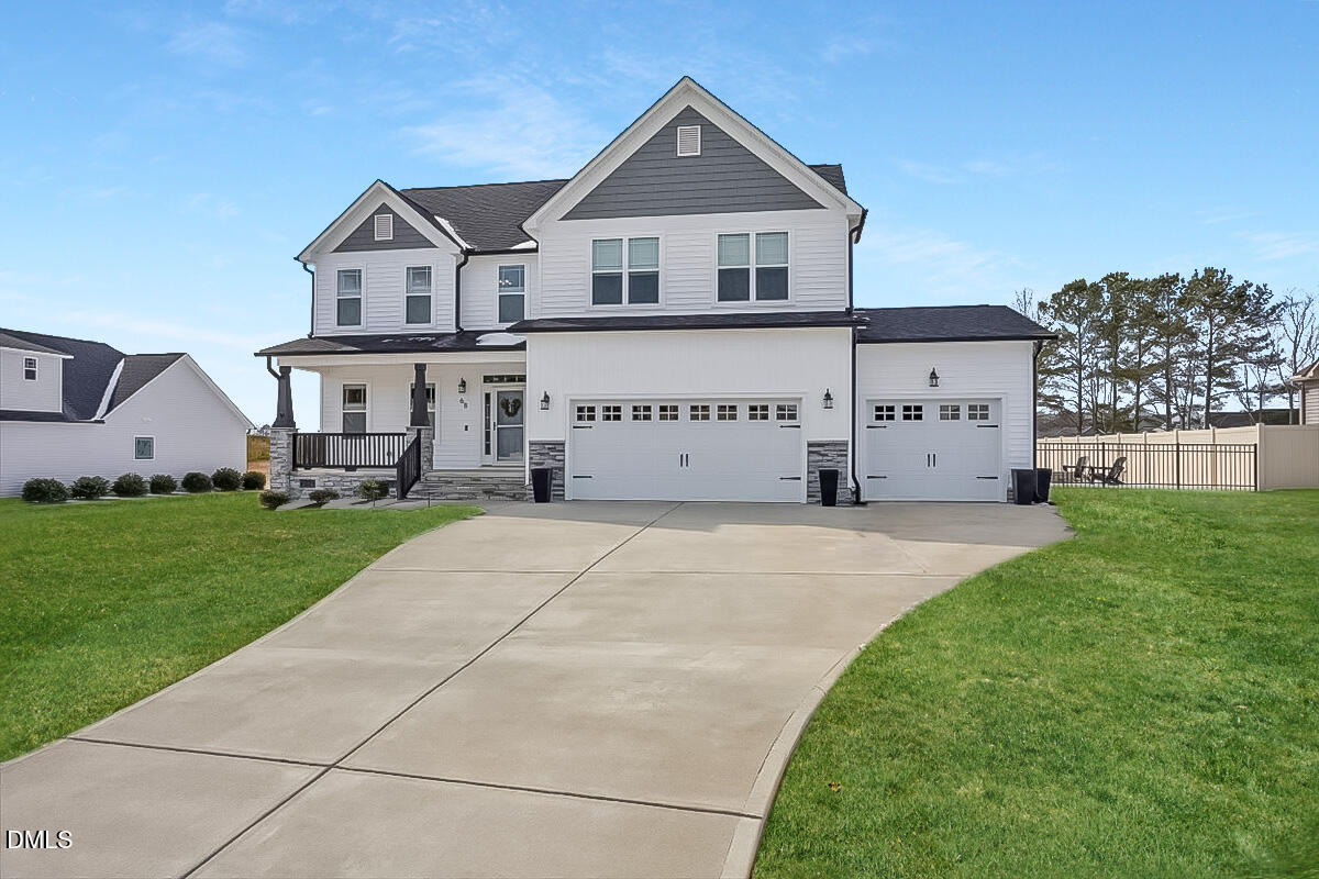 68 Bodacious Lane Benson, NC 27504 - Photo 1 of 39 a front view of a house with a yard and garage