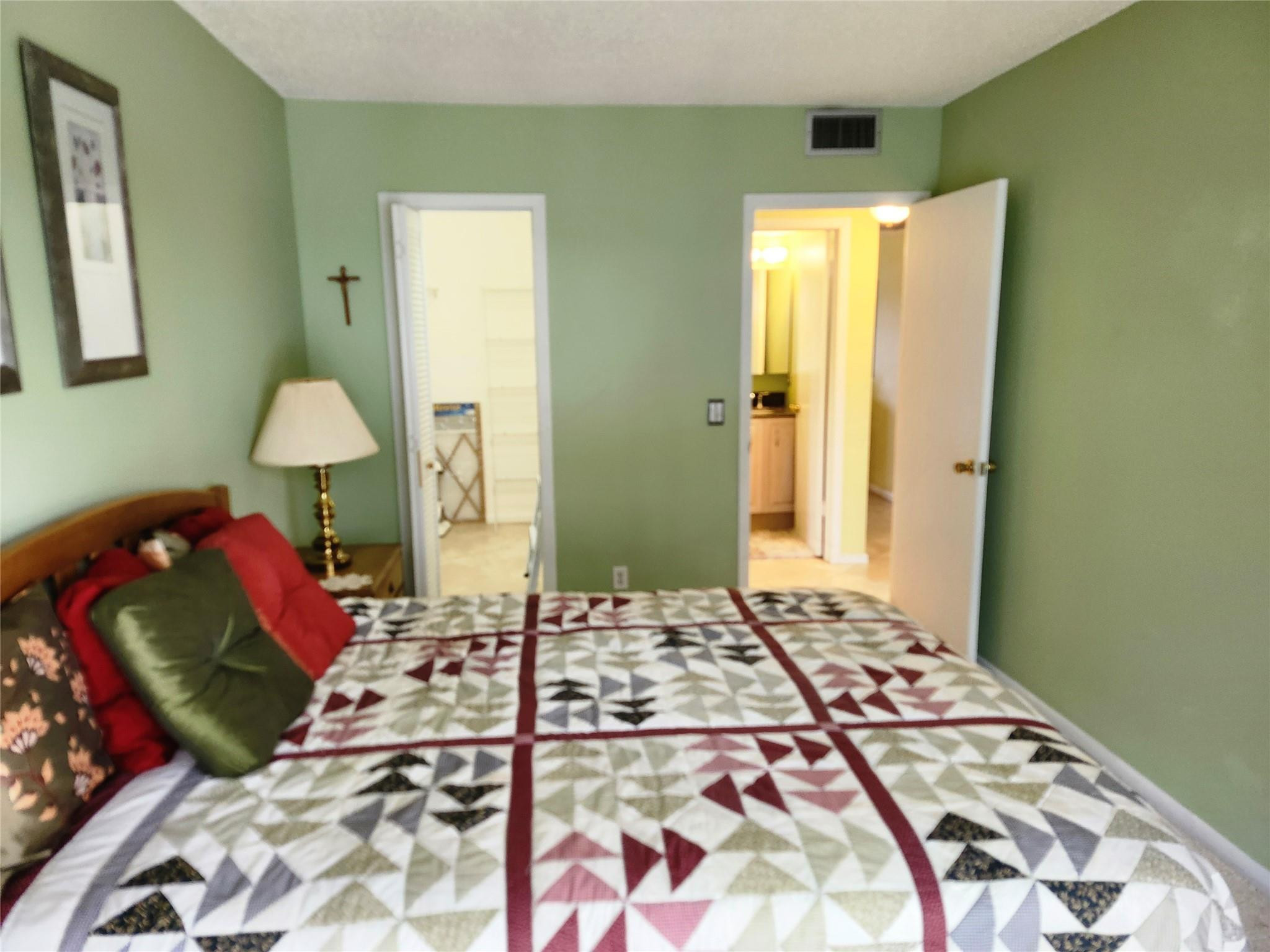 74 Preston Way Boca Raton, FL 33434 - Photo 18 of 28 a bedroom with a bed and a lamp on dresser