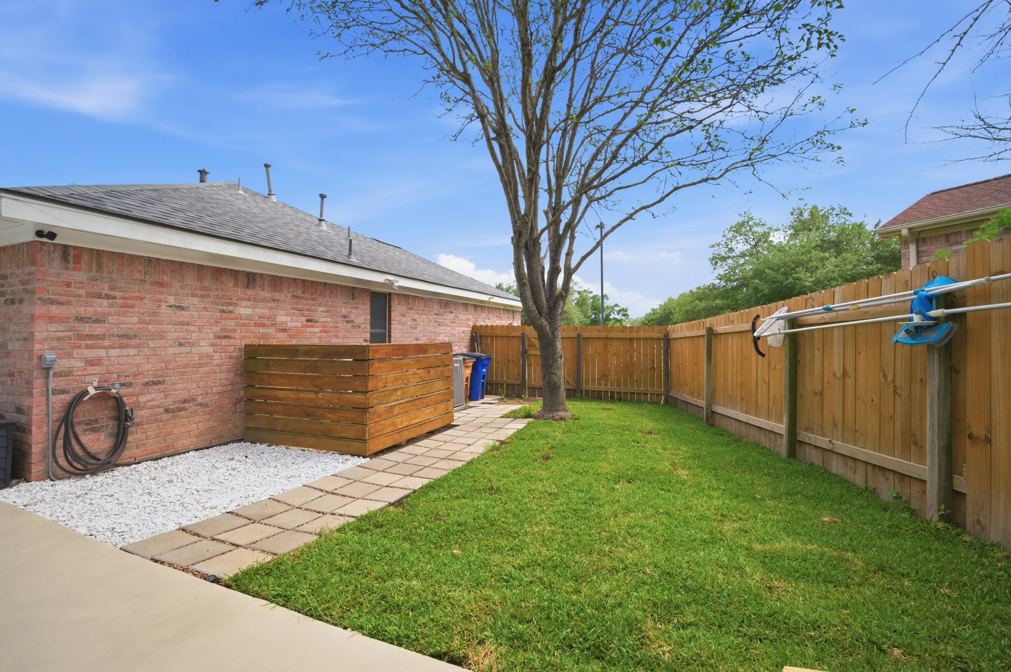9024 Heiden Lane Austin, TX 78749 - Photo 27 of 28 Private backyard featuring a manicured lawn, full privacy fencing, and a mature shade tree